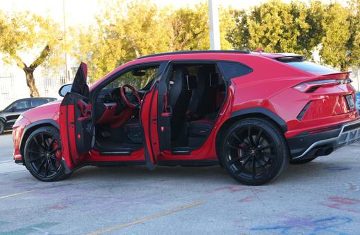 Red Lamborghini Urus with all four doors open